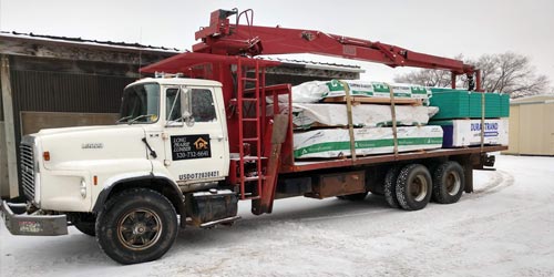 Long Prairie Lumber's delivery boom truck filled with materials for delivery